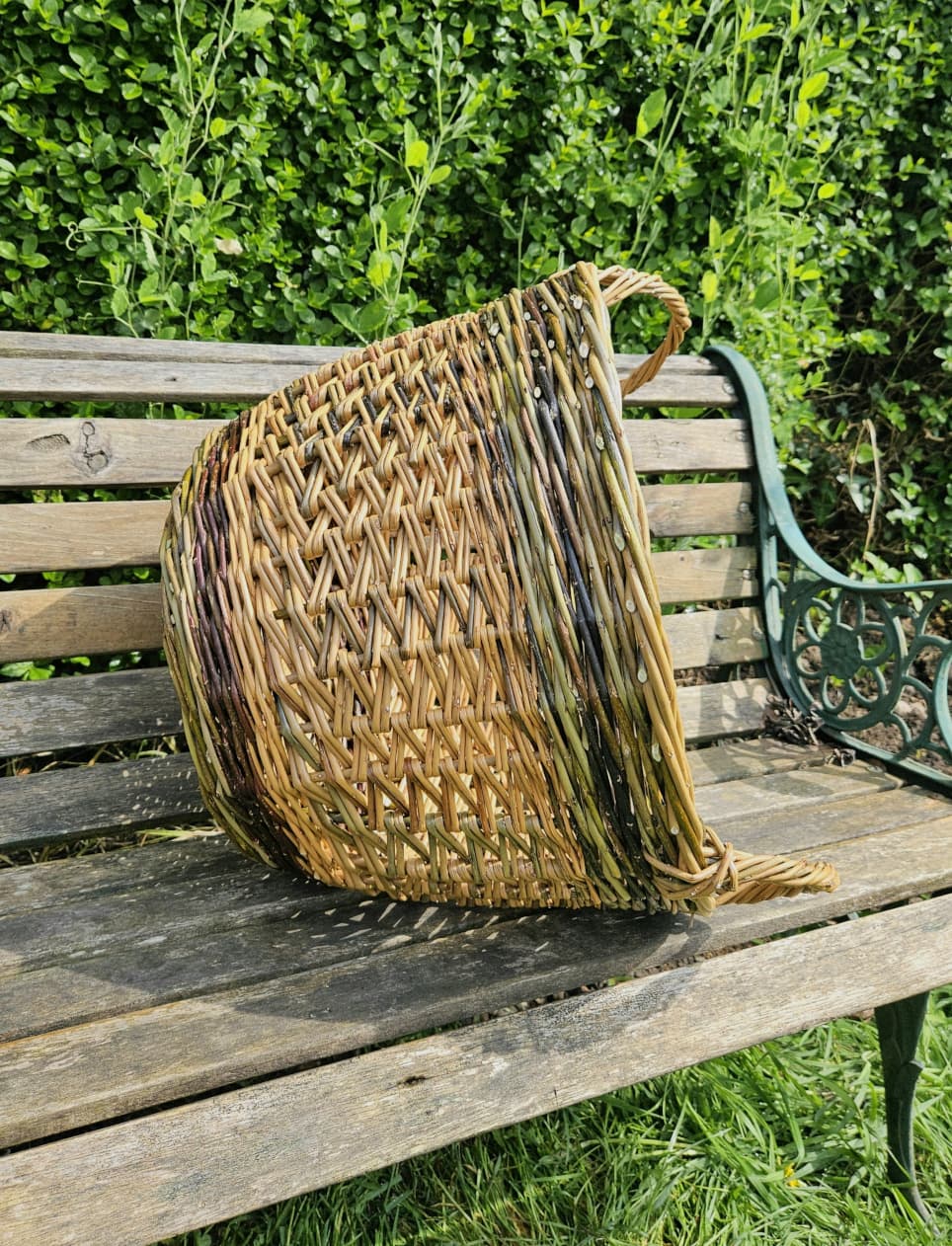 Oval willow basket on a wooden bench